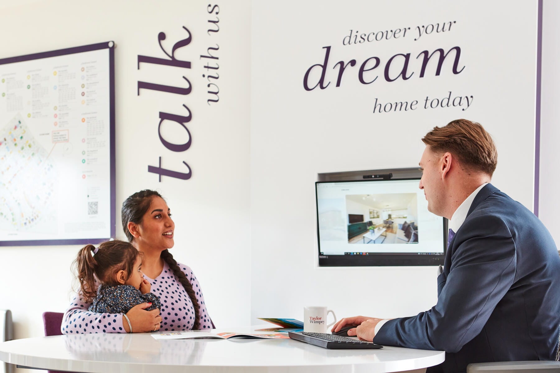 Couple in new Taylor Wimpey home lounge